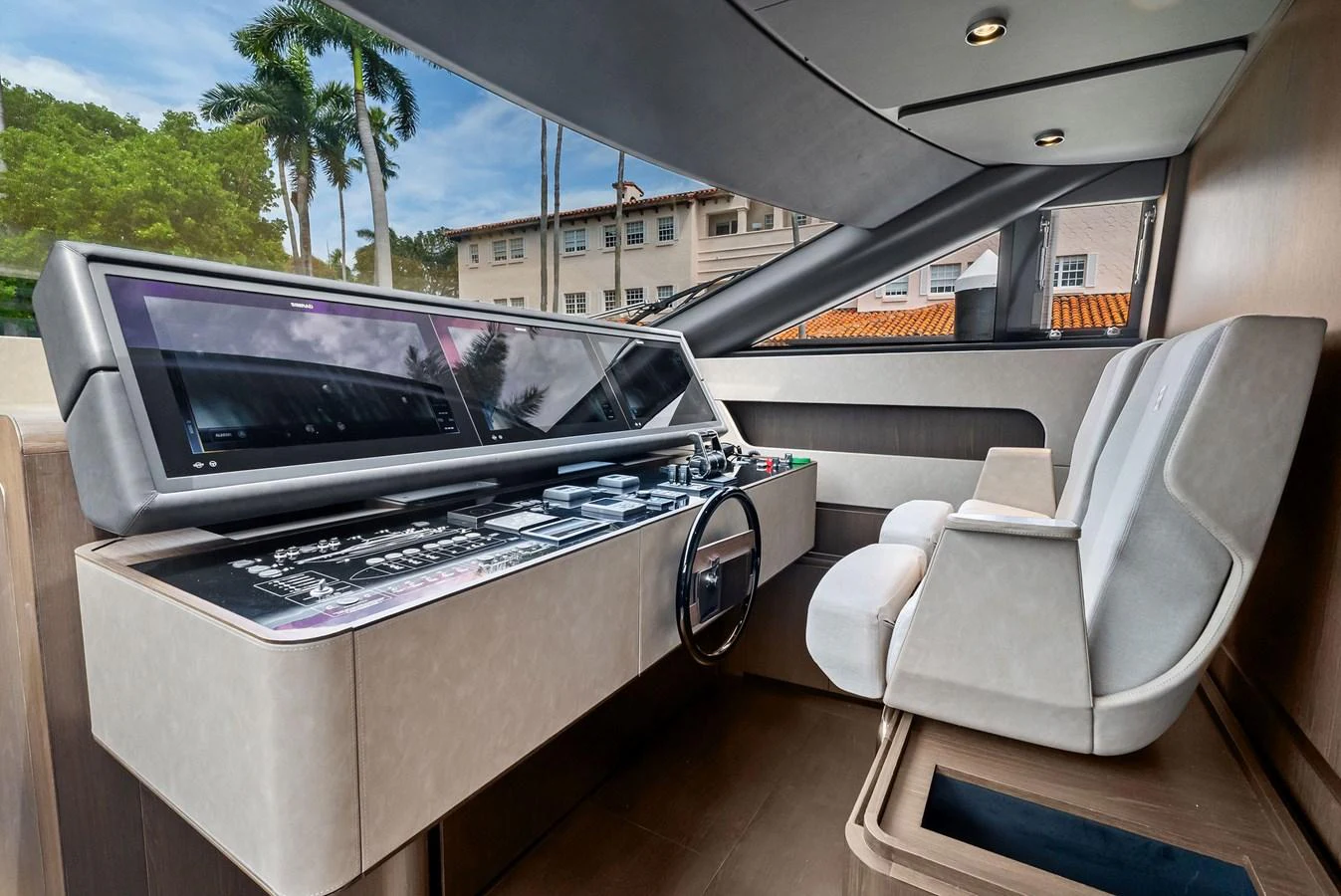 The helm station features modern controls and comfortable seating, offering a commanding view for navigation. aboard LADY F Yacht for Sale