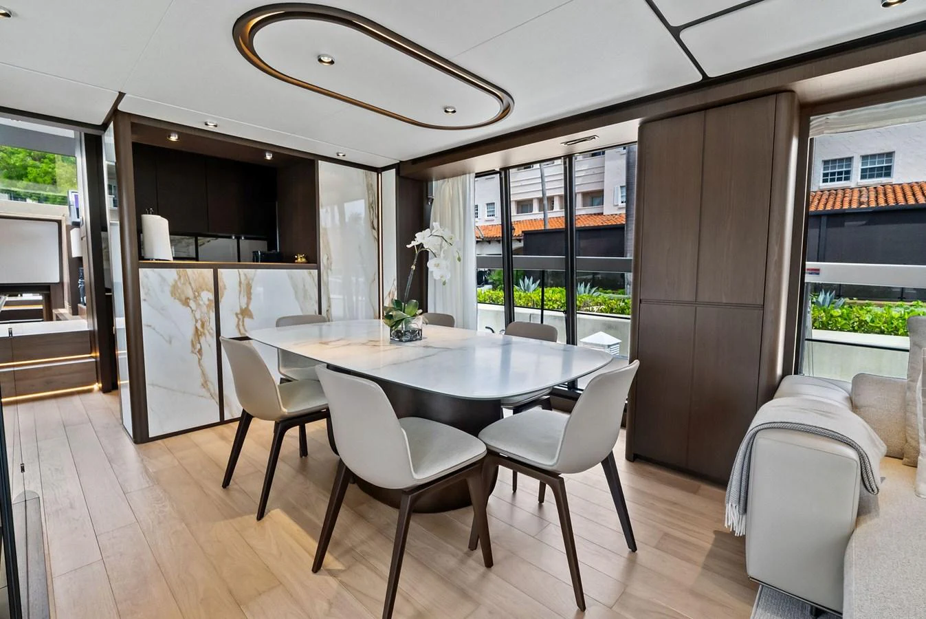The yacht's dining area features a modern table with stylish chairs, complemented by elegant decor and ample natural light. aboard LADY F Yacht for Sale