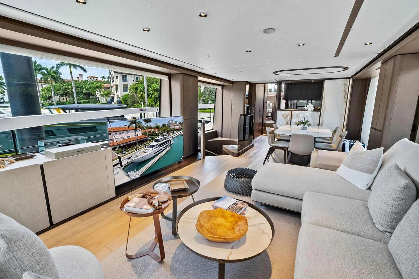 The salon features a spacious and modern design with comfortable seating and large windows offering scenic views. aboard LADY F Yacht for Sale