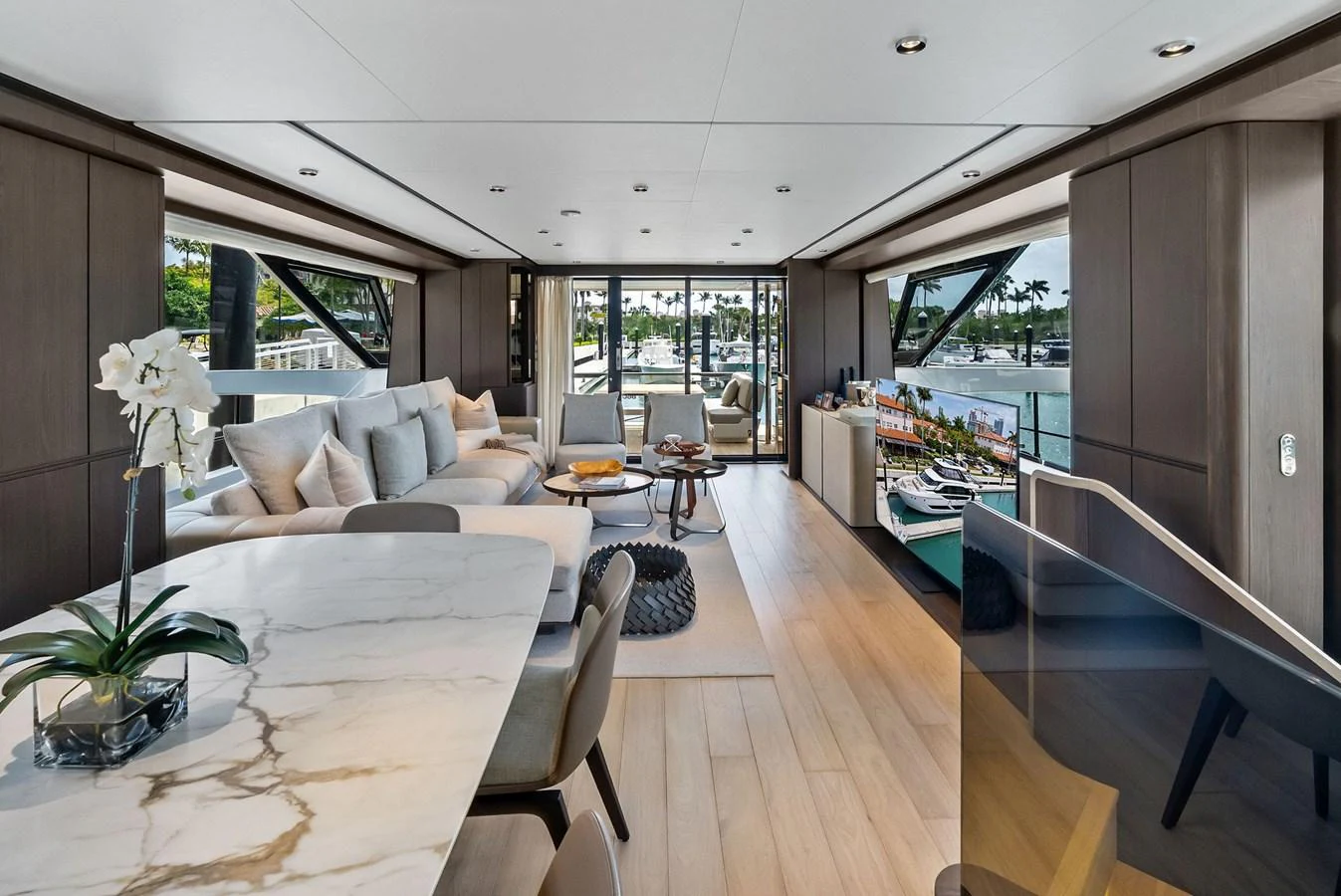 The salon features a spacious and elegant design with ample natural light and luxurious furnishings. aboard LADY F Yacht for Sale