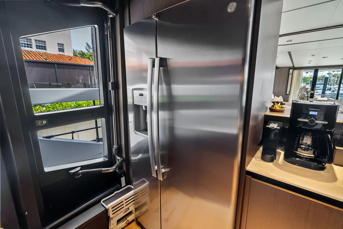 The yacht's galley features a modern stainless steel refrigerator and a coffee maker, ensuring convenience and luxury. aboard LADY F Yacht for Sale
