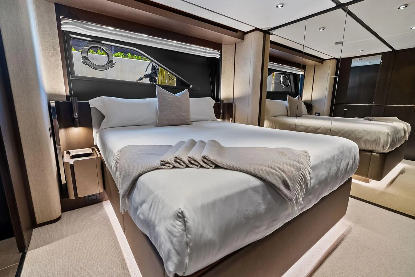The stateroom features a luxurious bed with elegant linens and modern decor. aboard LADY F Yacht for Sale