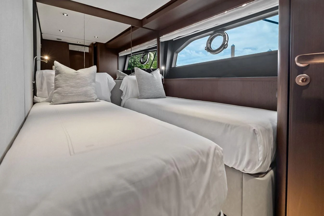 The twin stateroom offers a cozy and elegant sleeping area with two single beds and modern decor. aboard LADY F Yacht for Sale