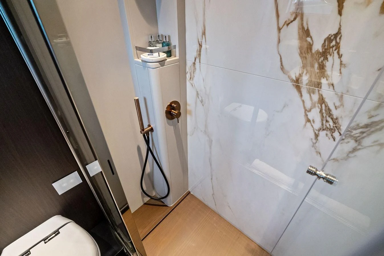 The yacht's bathroom features elegant marble walls and modern fixtures. aboard LADY F Yacht for Sale