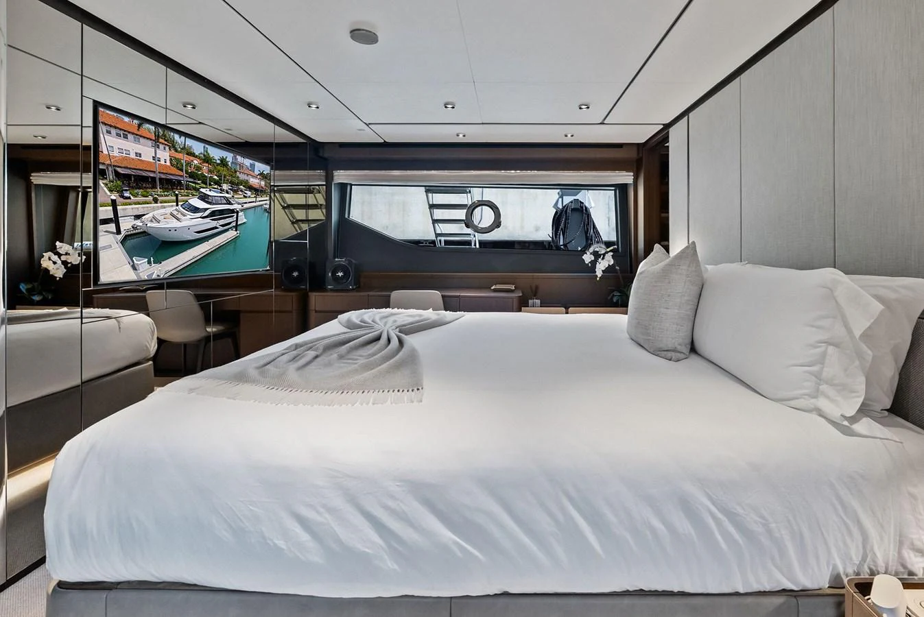 A luxurious stateroom featuring a large bed, modern decor, and a flat-screen TV. aboard LADY F Yacht for Sale