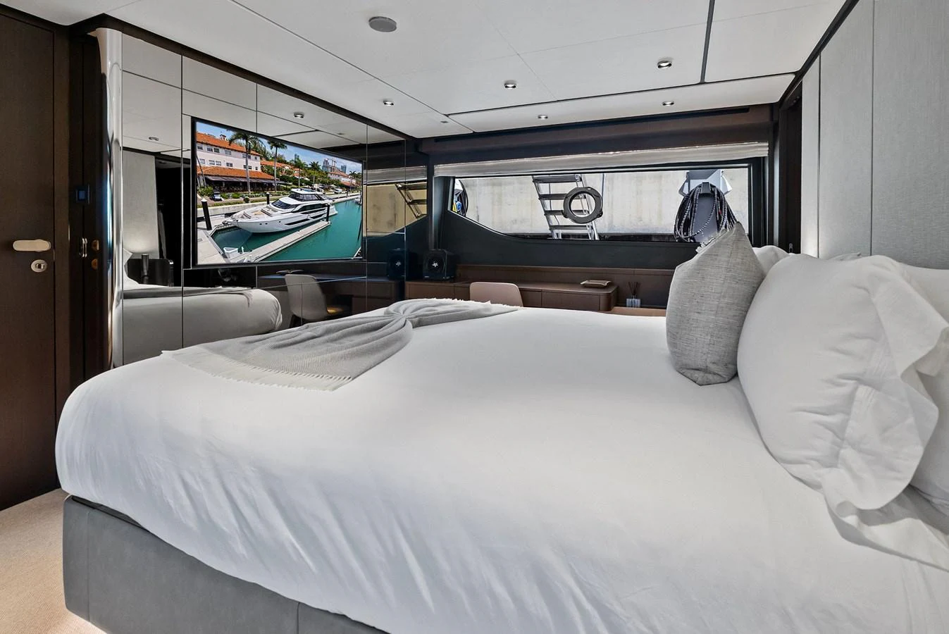 A luxurious stateroom featuring a large bed, modern decor, and a flat-screen TV. aboard LADY F Yacht for Sale
