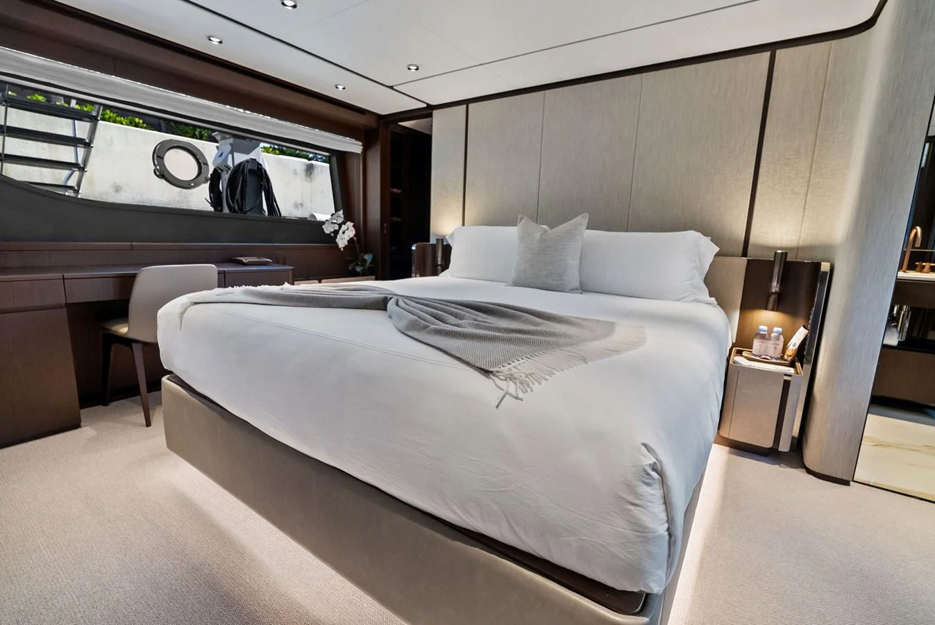 The stateroom features a luxurious bed with elegant bedding and modern furnishings. aboard LADY F Yacht for Sale
