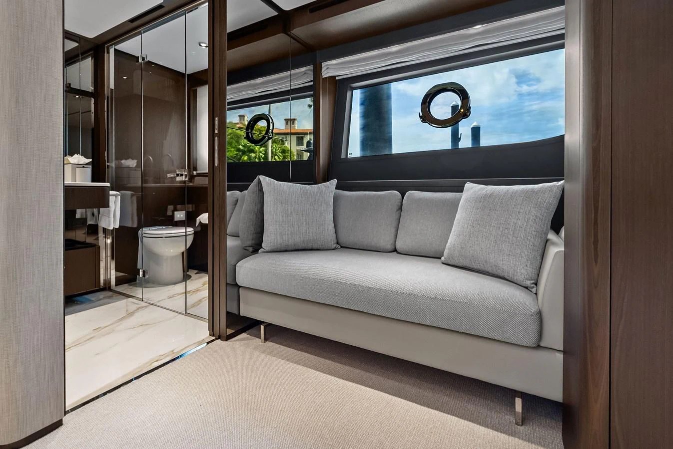 A cozy stateroom featuring a comfortable sofa and an en-suite bathroom with modern fixtures. aboard LADY F Yacht for Sale