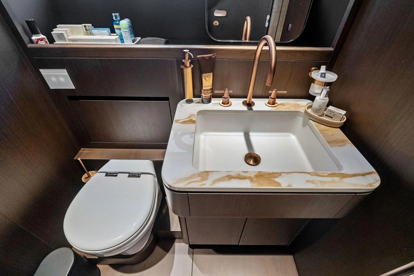 A luxurious yacht bathroom featuring a marble-topped sink and modern fixtures. aboard LADY F Yacht for Sale