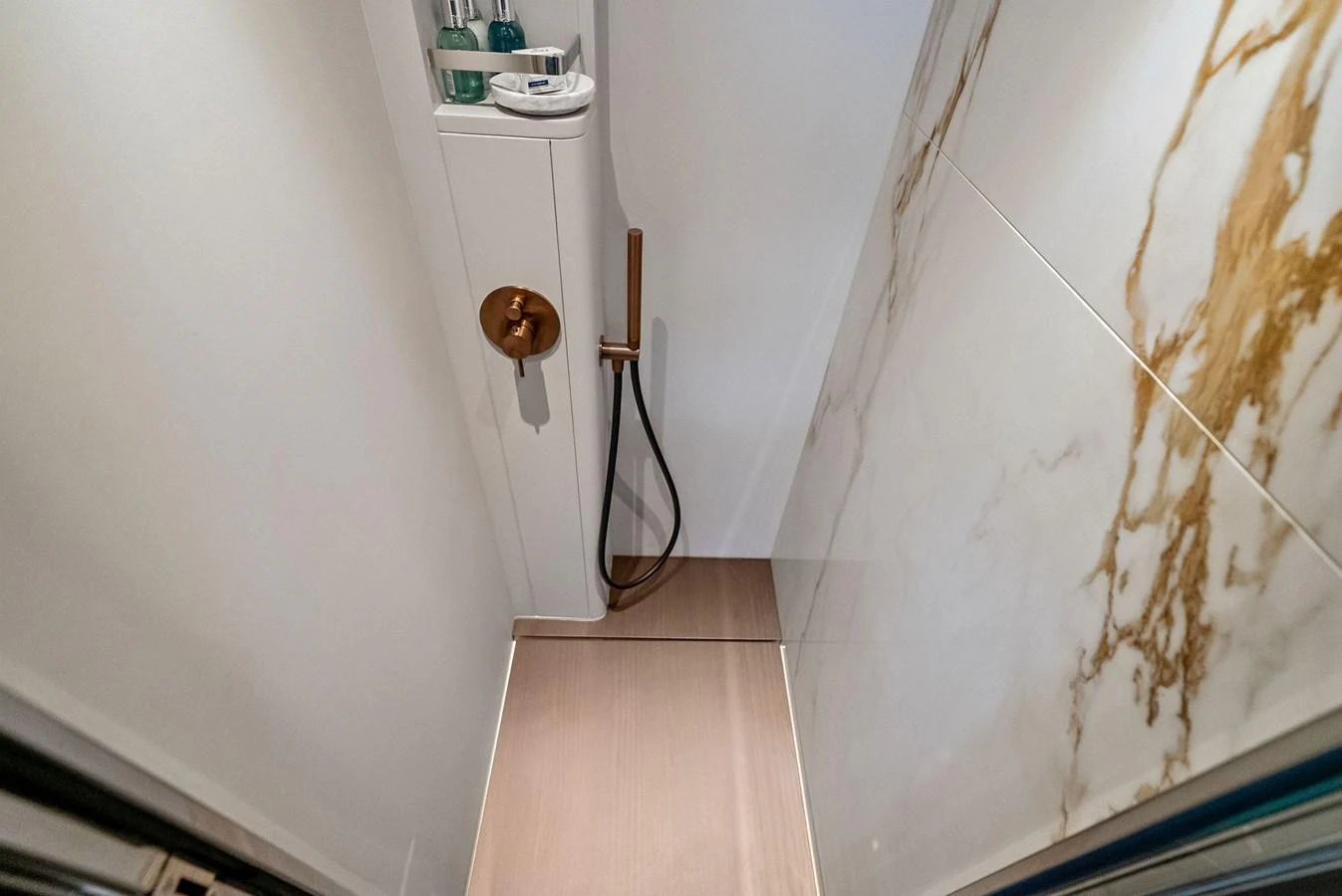 A compact and modern yacht bathroom with elegant fixtures and marble accents. aboard LADY F Yacht for Sale