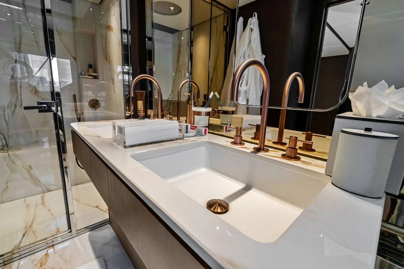The yacht's bathroom features a luxurious design with elegant fixtures and a spacious sink area. aboard LADY F Yacht for Sale