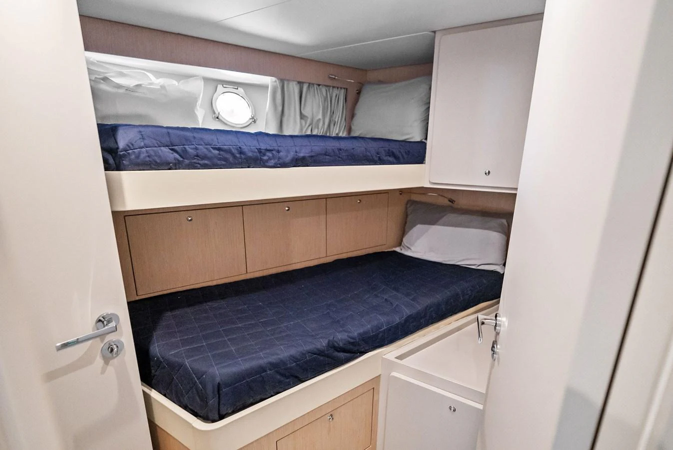 The guest cabin features cozy bunk beds with ample storage space. aboard LADY F Yacht for Sale