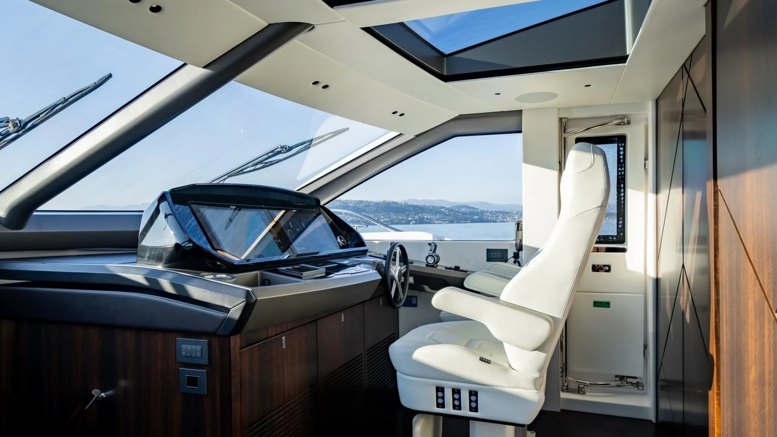 The helm station offers a sleek and modern design with panoramic views and advanced navigation equipment. aboard TRIPLE EIGHT Yacht for Sale