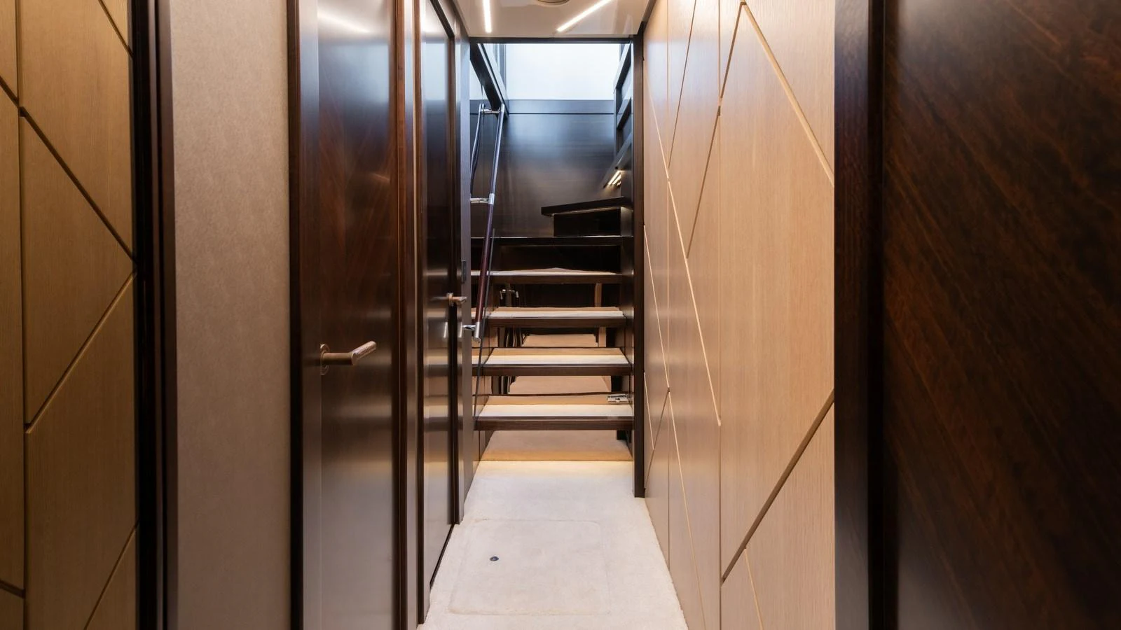 A modern interior hallway with a staircase leading to an upper level. aboard TRIPLE EIGHT Yacht for Sale