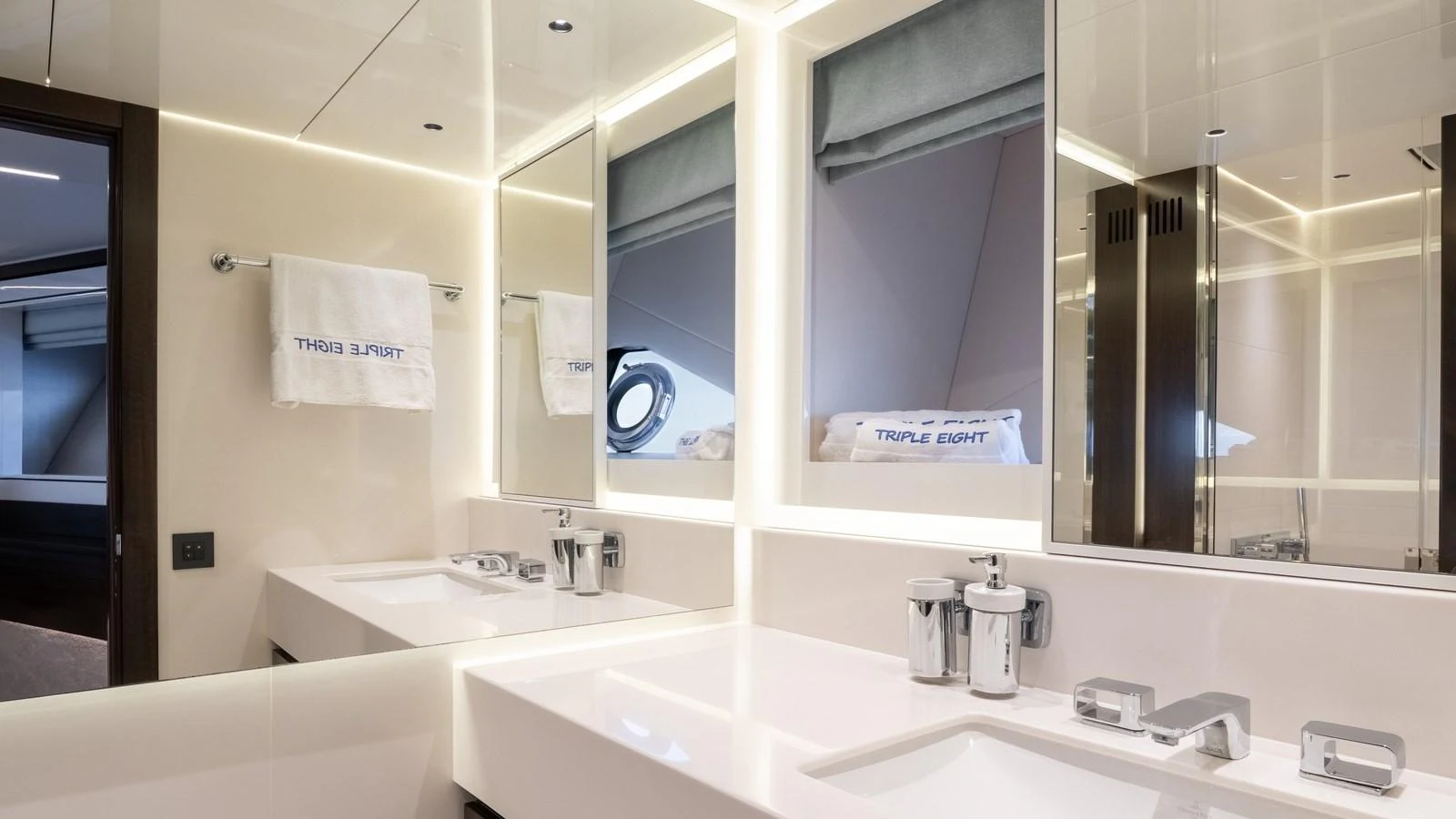 The yacht's bathroom features a sleek, modern design with dual sinks and ample lighting. aboard TRIPLE EIGHT Yacht for Sale