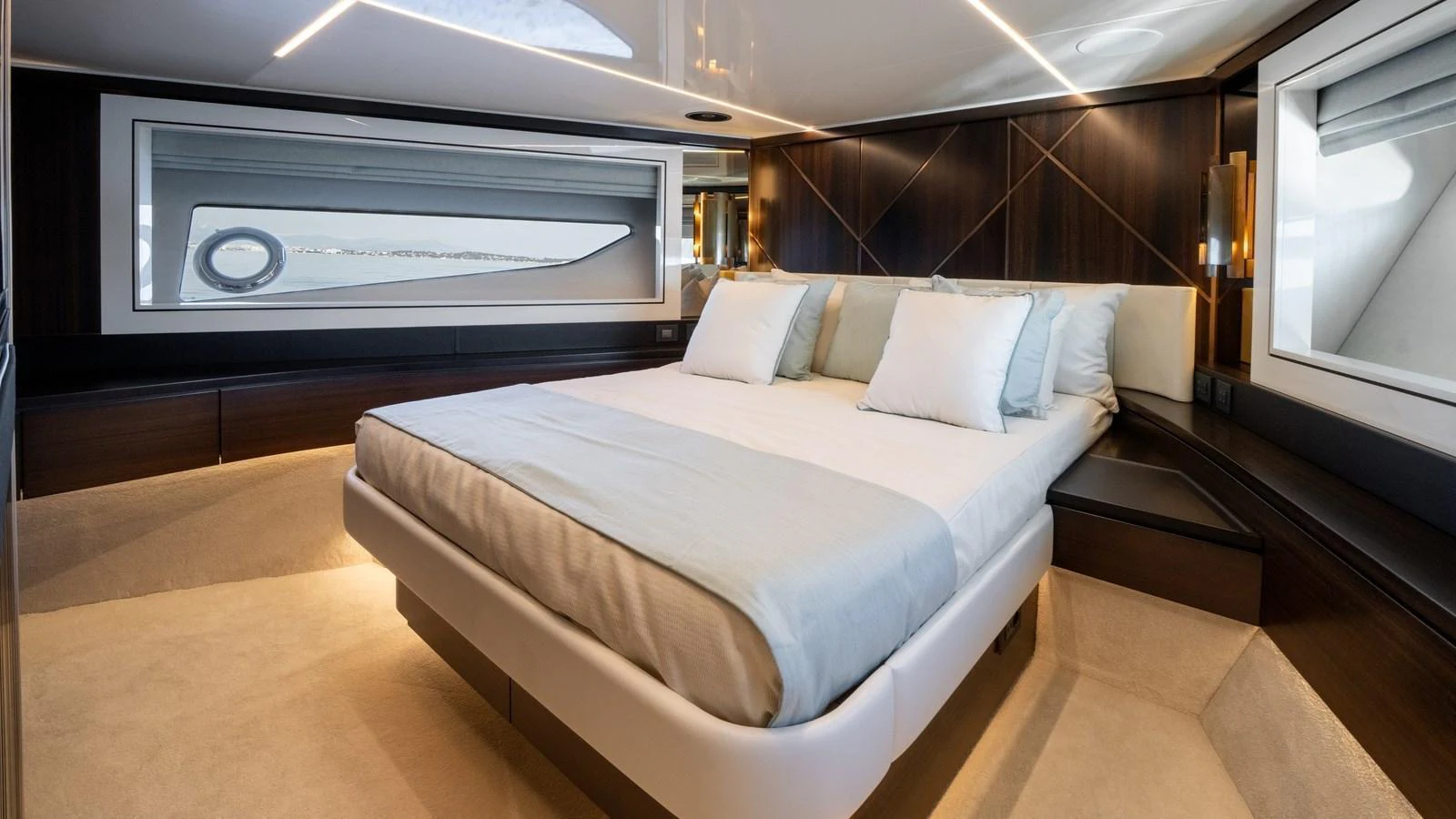 The master stateroom features a luxurious bed with elegant wood paneling and ample natural light. aboard TRIPLE EIGHT Yacht for Sale