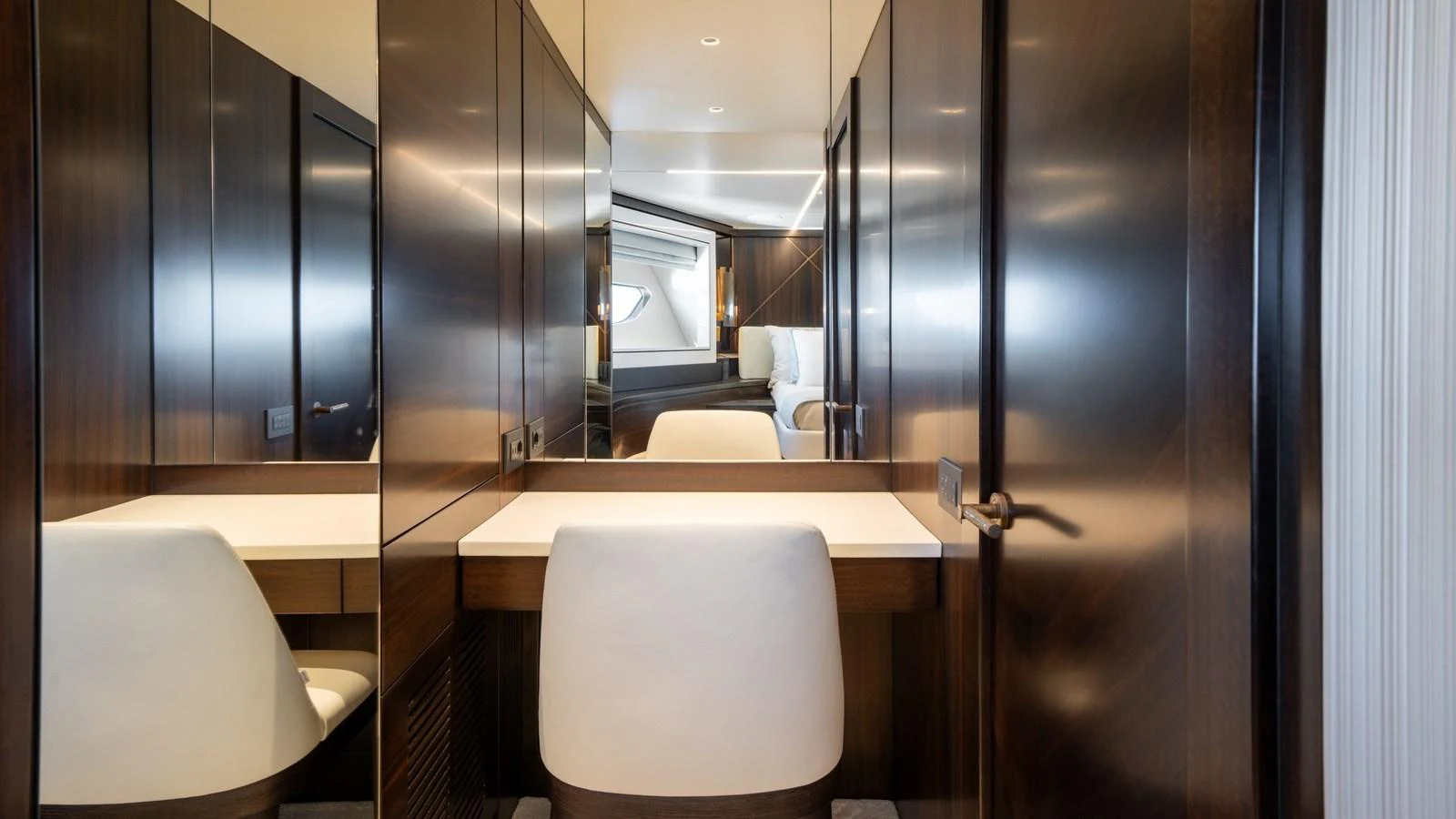 The yacht's interior features a sleek and modern design with dark wood paneling and a comfortable seating area. aboard TRIPLE EIGHT Yacht for Sale