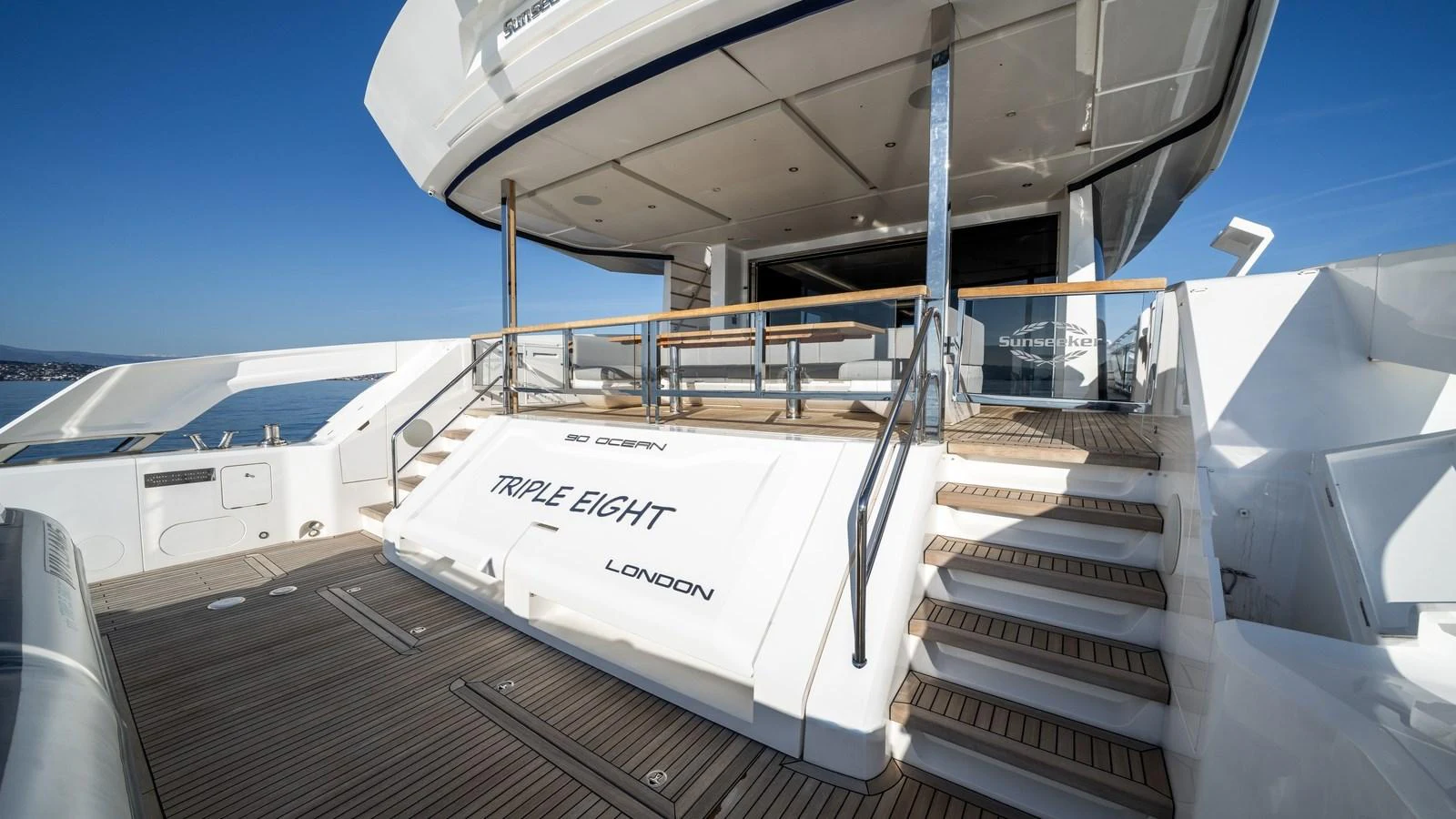 The aft deck features a spacious area with elegant steps leading to the upper level. aboard TRIPLE EIGHT Yacht for Sale