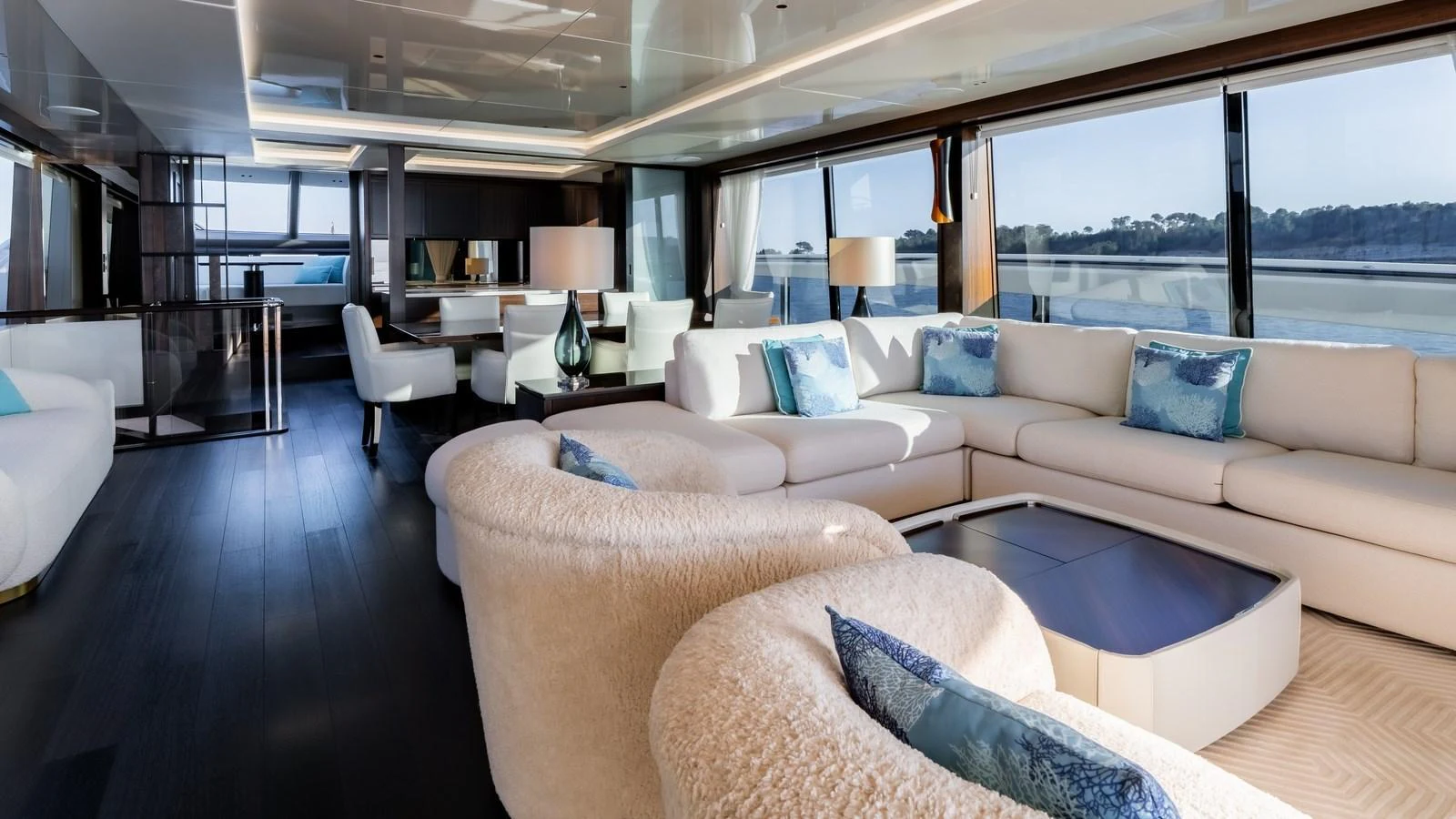 The luxurious salon features plush seating, elegant decor, and expansive windows offering stunning views. aboard TRIPLE EIGHT Yacht for Sale