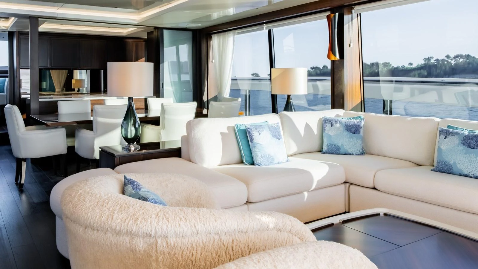 The salon features luxurious seating with panoramic views of the water. aboard TRIPLE EIGHT Yacht for Sale