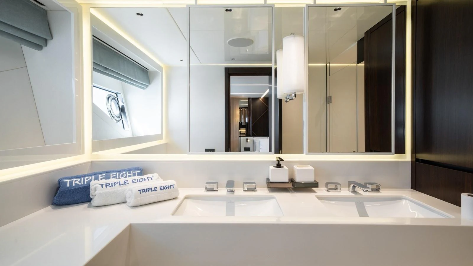 The yacht's bathroom features a sleek, modern design with double sinks and ample lighting. aboard TRIPLE EIGHT Yacht for Sale