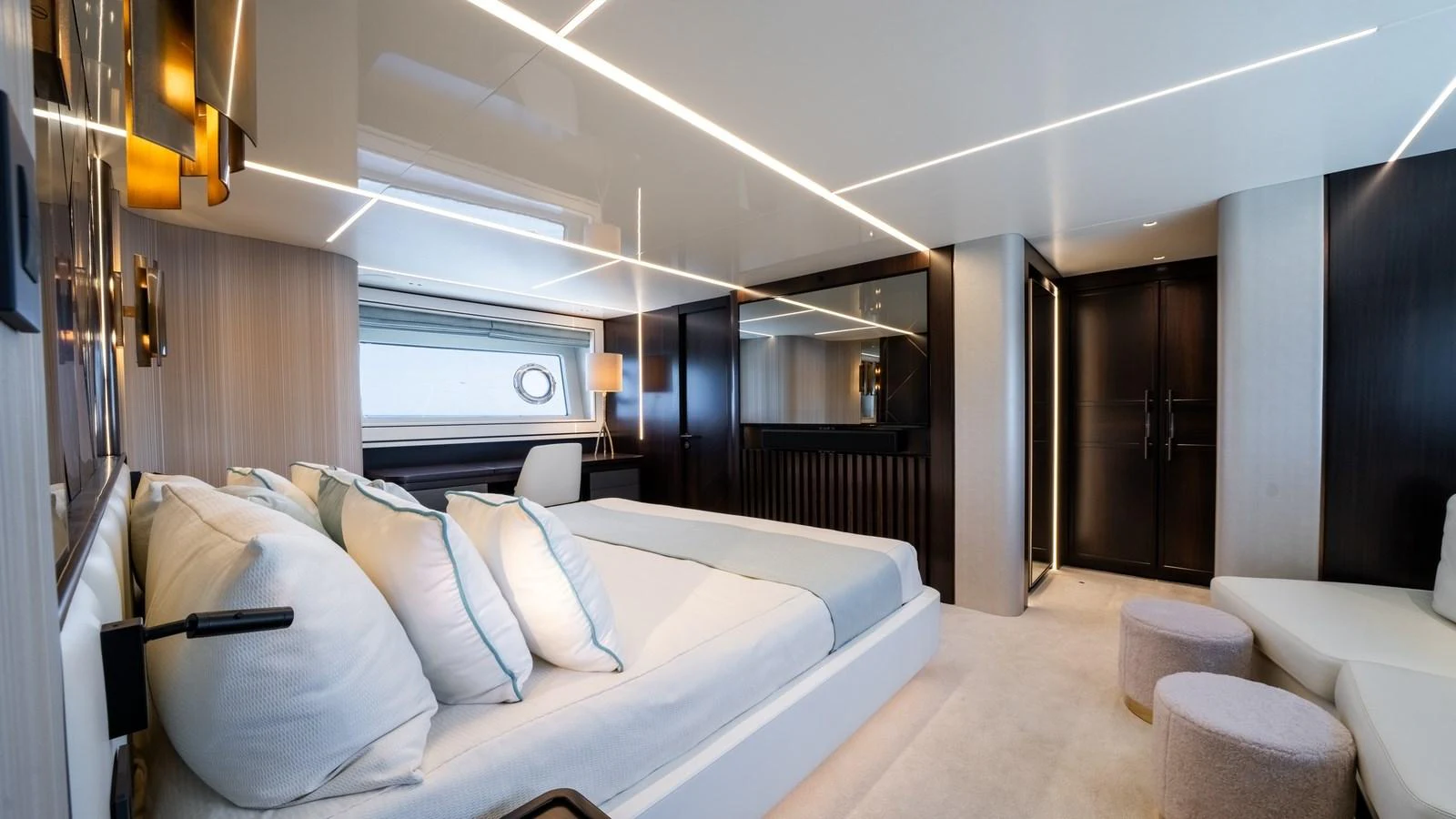 The master stateroom features a luxurious bed with ample pillows, modern lighting, and elegant decor. aboard TRIPLE EIGHT Yacht for Sale