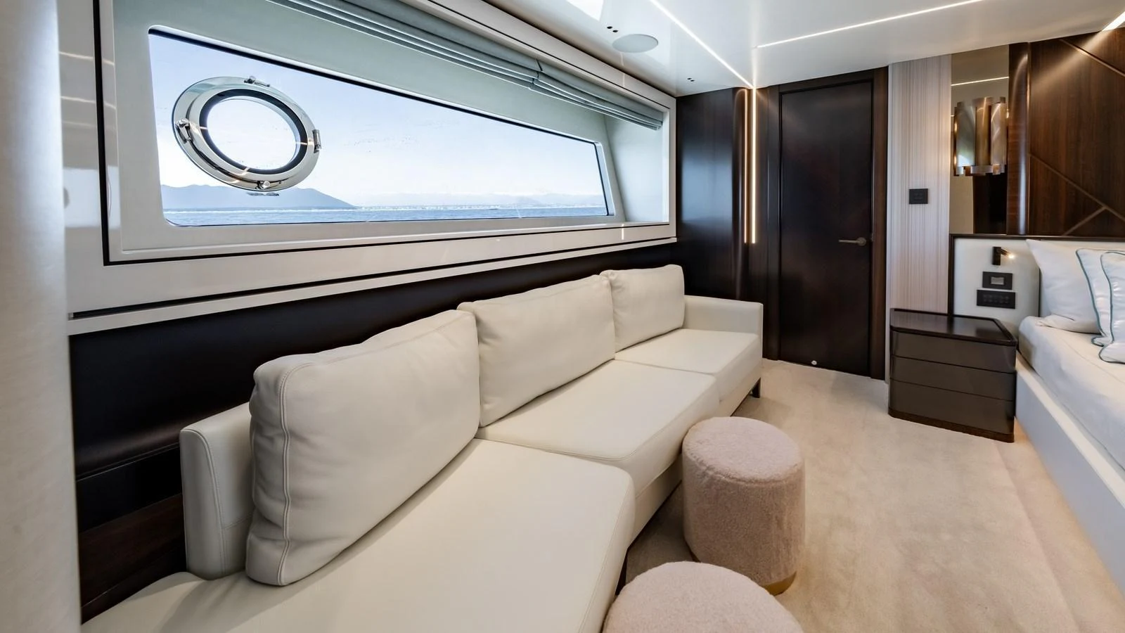 The salon features a comfortable seating area with a large window offering scenic views. aboard TRIPLE EIGHT Yacht for Sale