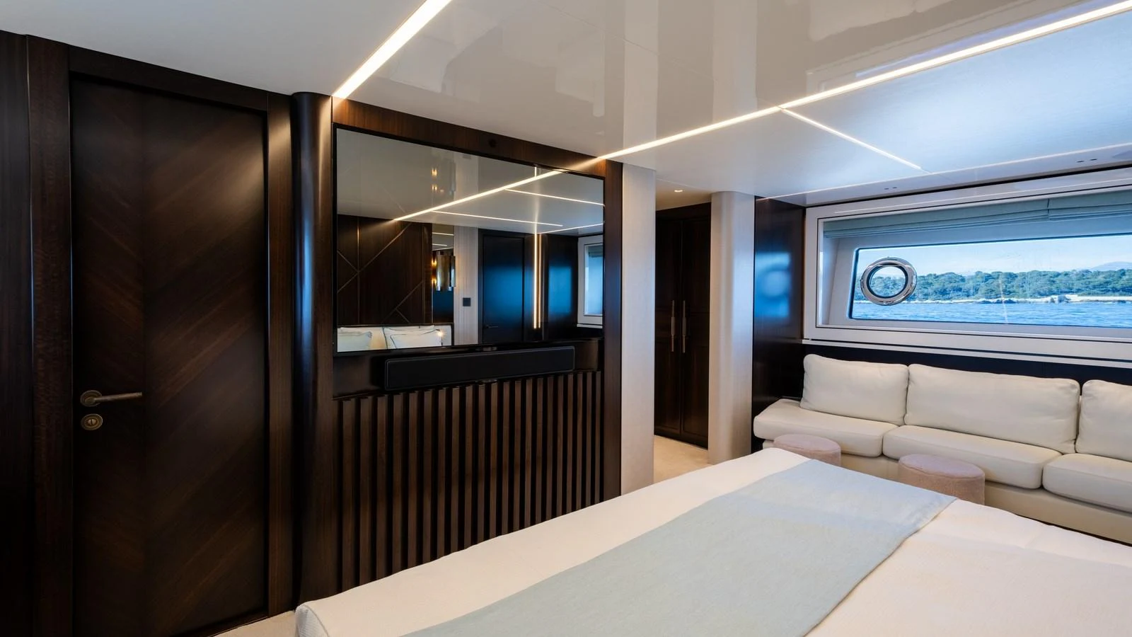 The stateroom features elegant wood finishes and a large window offering scenic views. aboard TRIPLE EIGHT Yacht for Sale