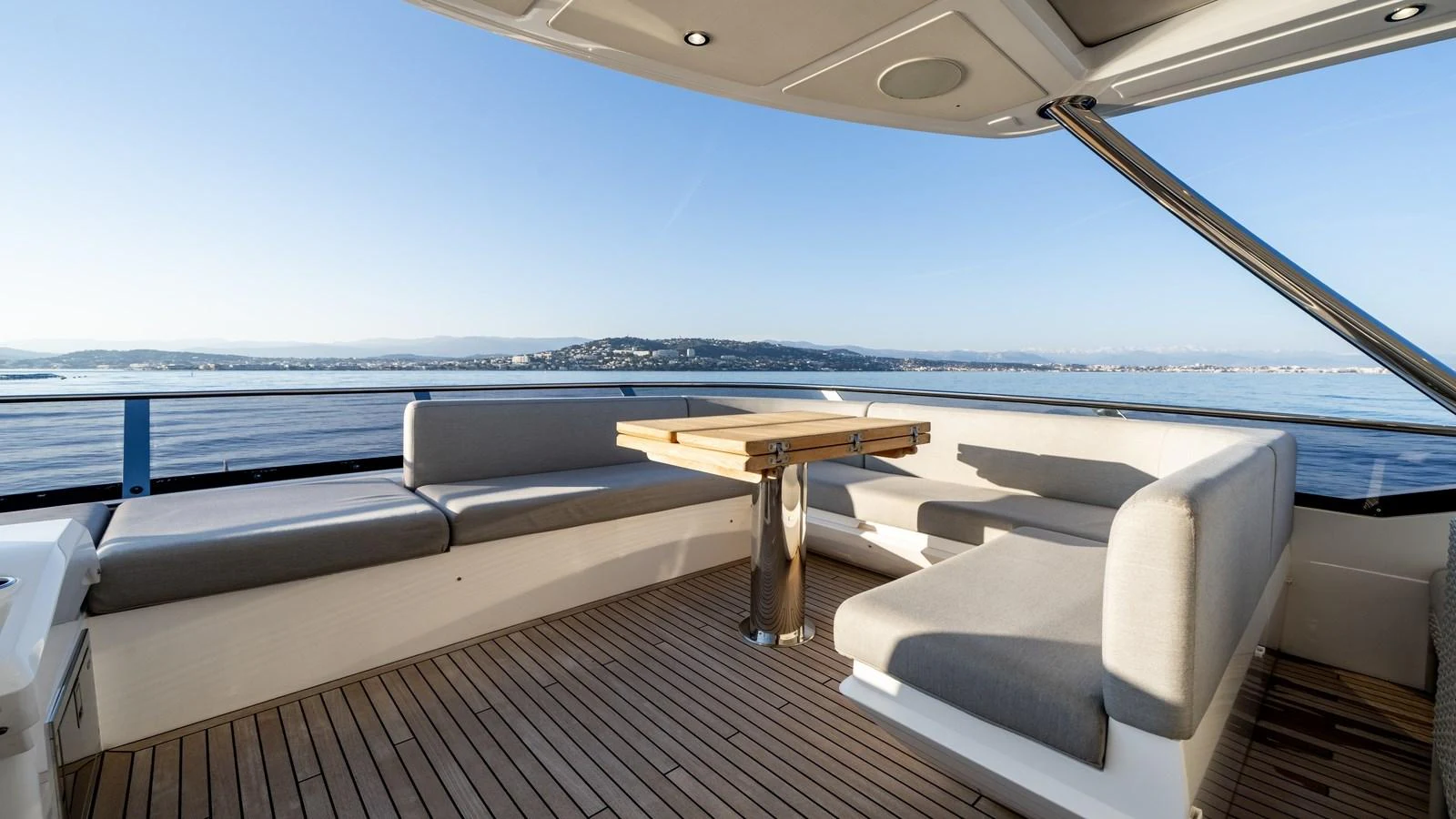 The aft deck offers a spacious seating area with a wooden table, perfect for enjoying the scenic views. aboard TRIPLE EIGHT Yacht for Sale