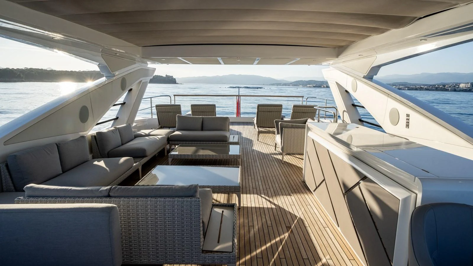 The aft deck features a spacious seating area with modern furnishings and panoramic views. aboard TRIPLE EIGHT Yacht for Sale