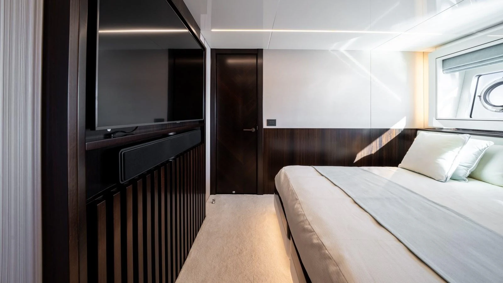 A luxurious stateroom featuring a large bed, modern decor, and a flat-screen TV. aboard TRIPLE EIGHT Yacht for Sale