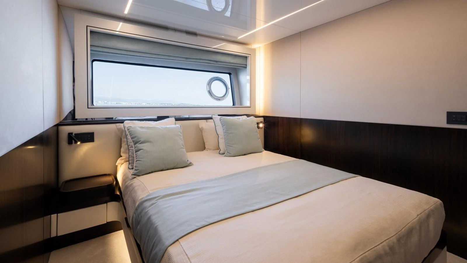 A cozy stateroom with a large window offering a serene view. aboard TRIPLE EIGHT Yacht for Sale