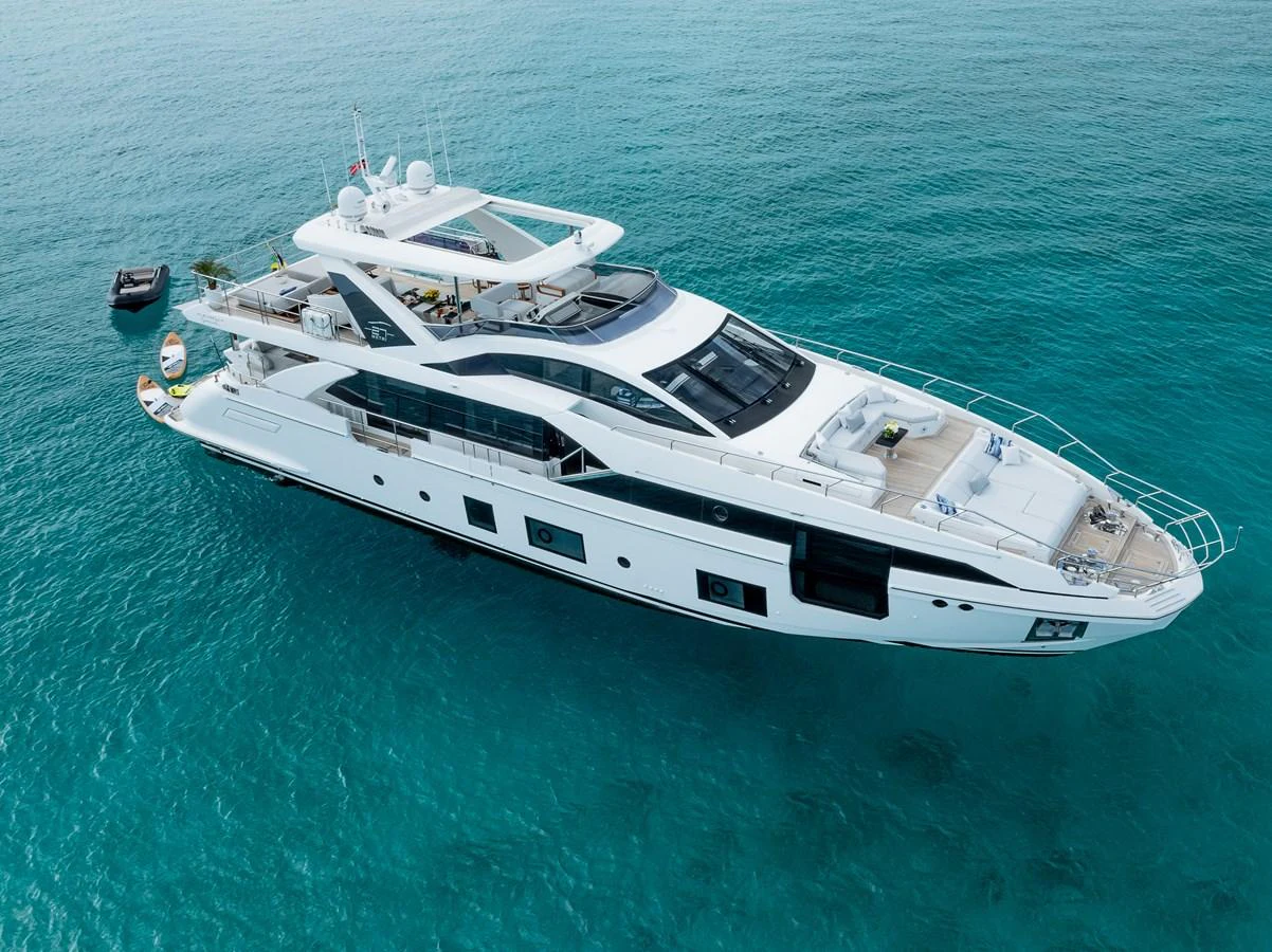 A sleek and modern yacht cruising on clear blue waters, showcasing its elegant design and spacious decks. aboard PIER PRESSURE Yacht for Sale
