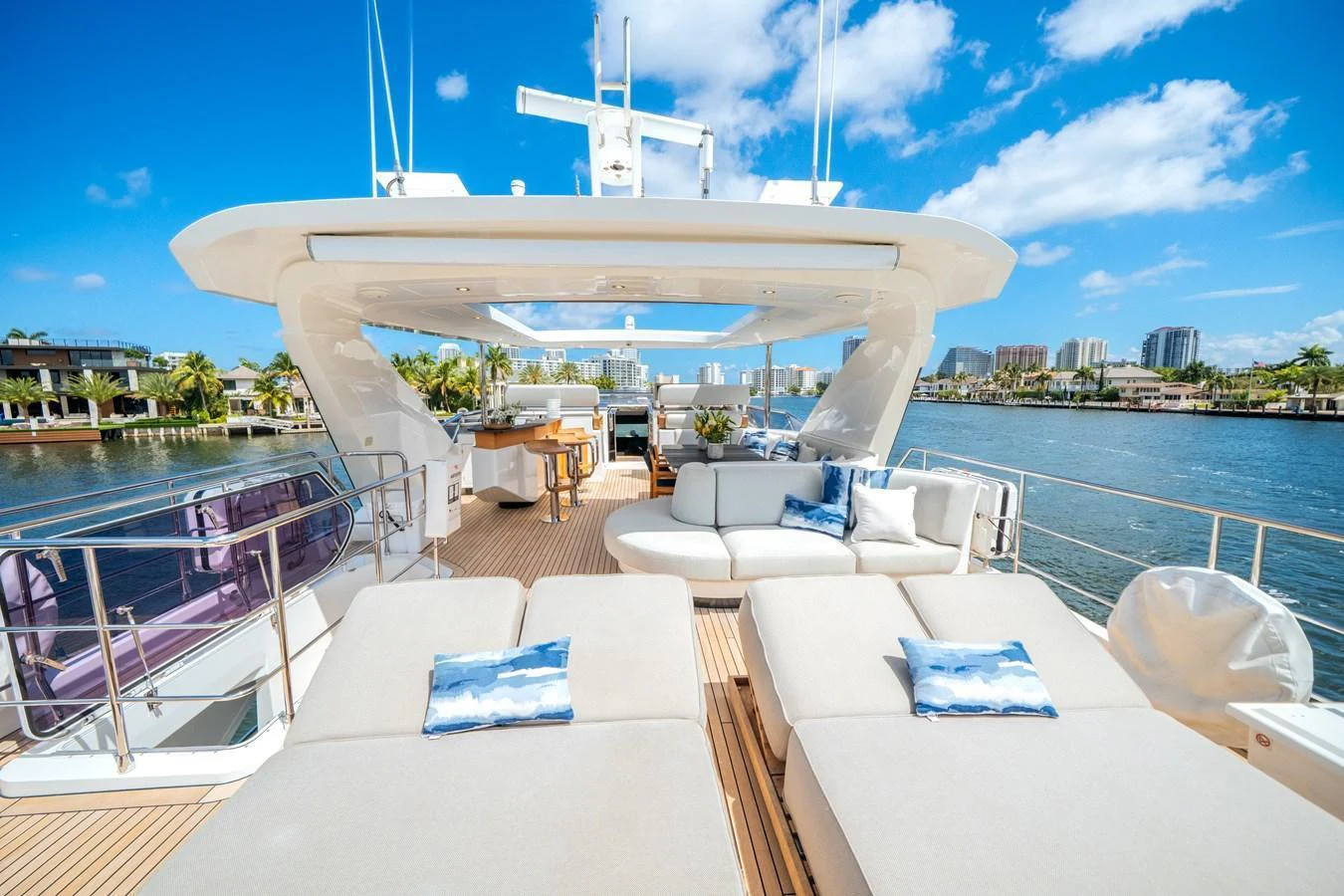 The sundeck offers luxurious lounging with plush seating and stunning waterfront views. aboard PIER PRESSURE Yacht for Sale