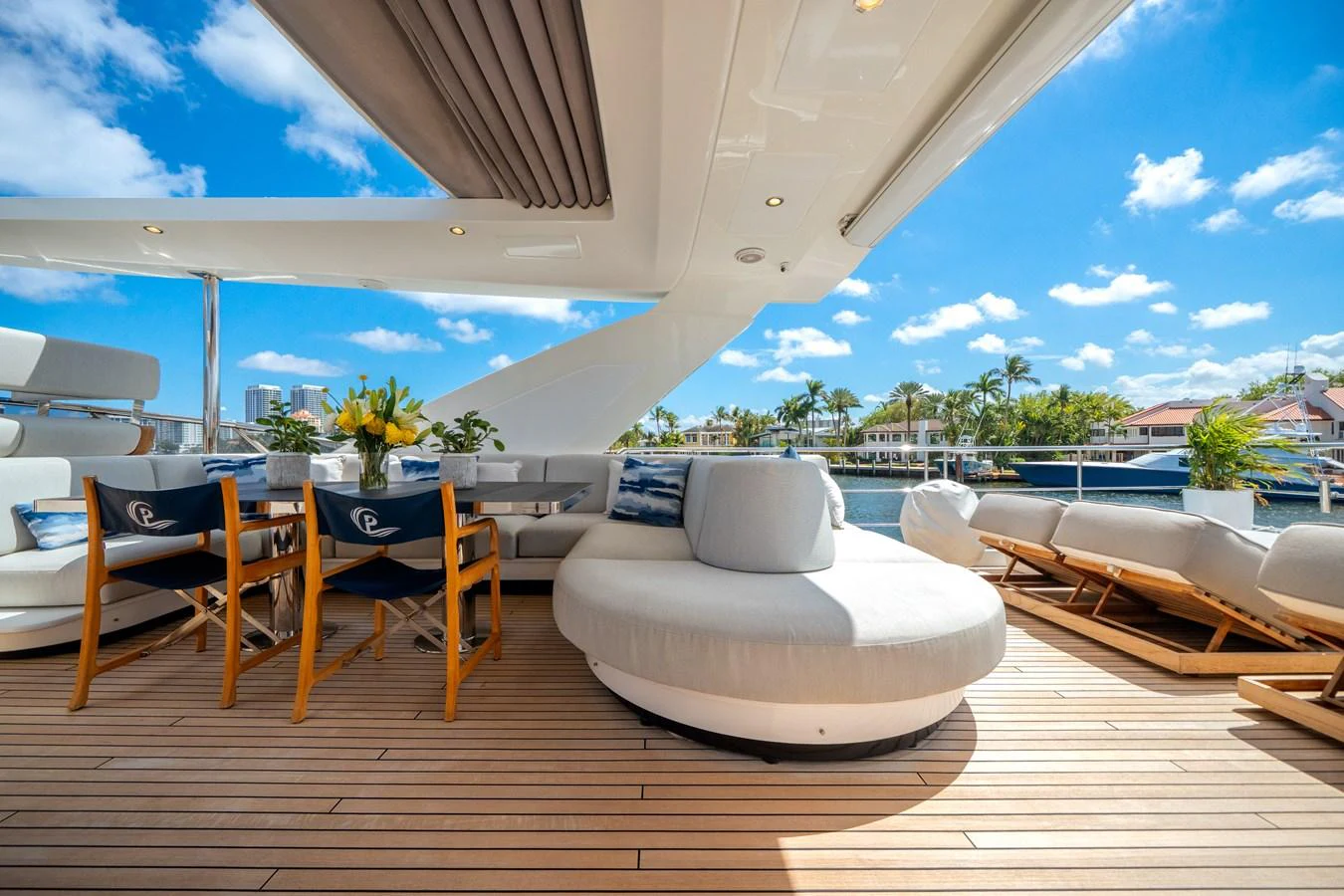 The aft deck features luxurious seating and dining areas with a stunning view of the water. aboard PIER PRESSURE Yacht for Sale