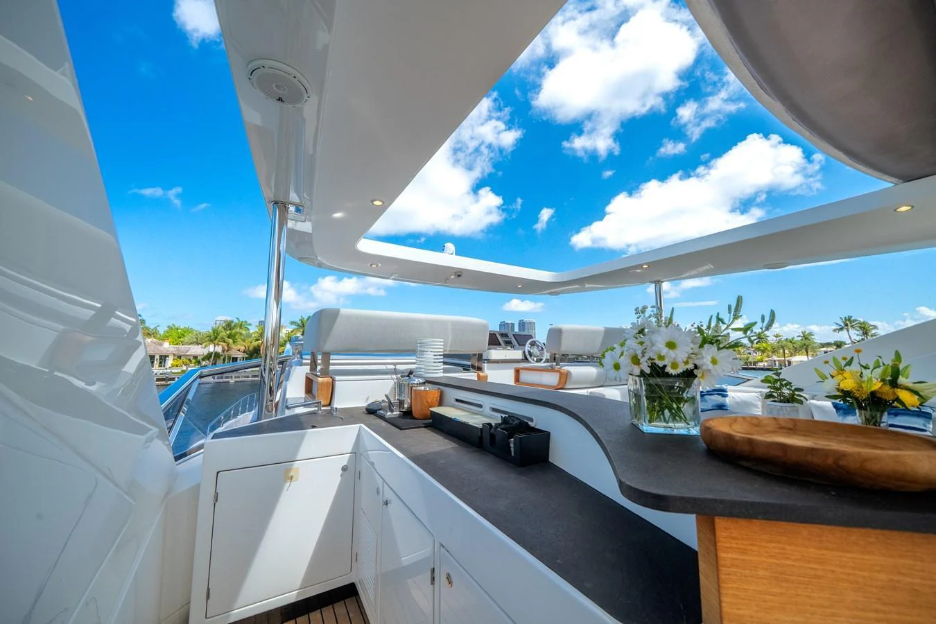The flybridge offers a luxurious outdoor kitchen area with stunning views and ample seating. aboard PIER PRESSURE Yacht for Sale