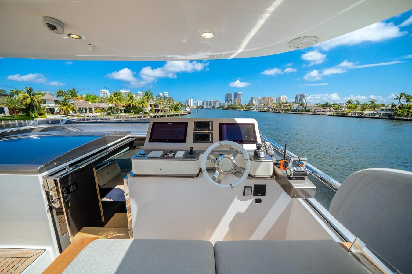 The helm station offers a panoramic view of the waterway, blending advanced navigation technology with luxurious comfort. aboard PIER PRESSURE Yacht for Sale