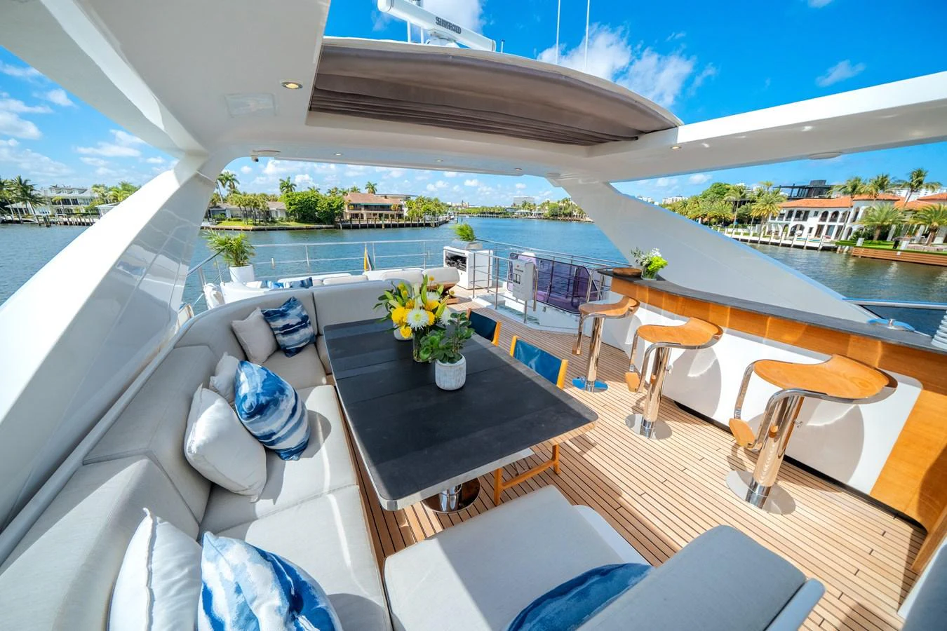 The flybridge offers a luxurious outdoor seating and dining area with stunning views of the water. aboard PIER PRESSURE Yacht for Sale