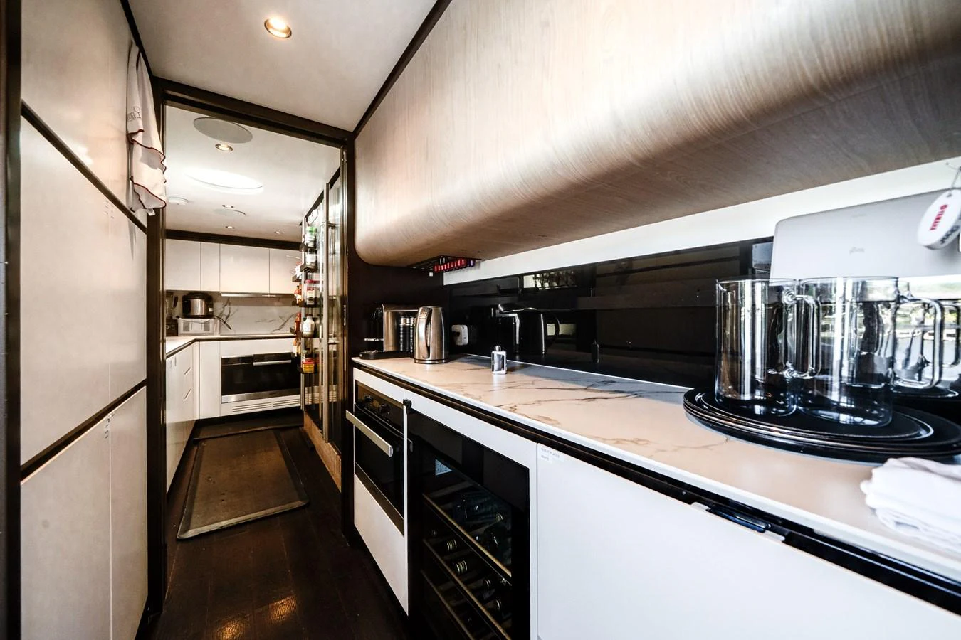 The galley is equipped with modern appliances and sleek countertops, offering a stylish and functional space for meal preparation. aboard PIER PRESSURE Yacht for Sale