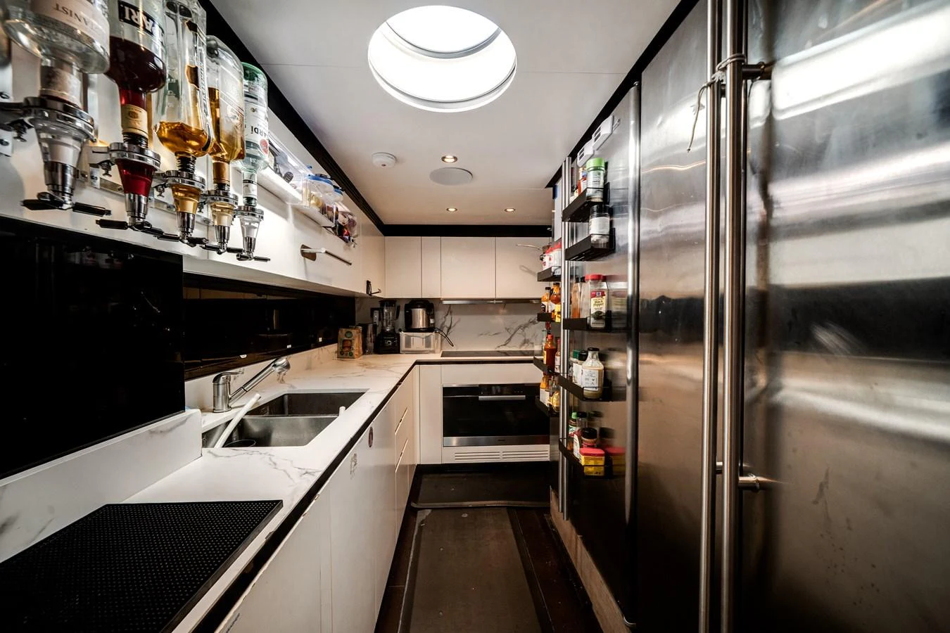 The yacht's galley features modern appliances and ample storage, creating a sleek and functional space for culinary activities. aboard PIER PRESSURE Yacht for Sale
