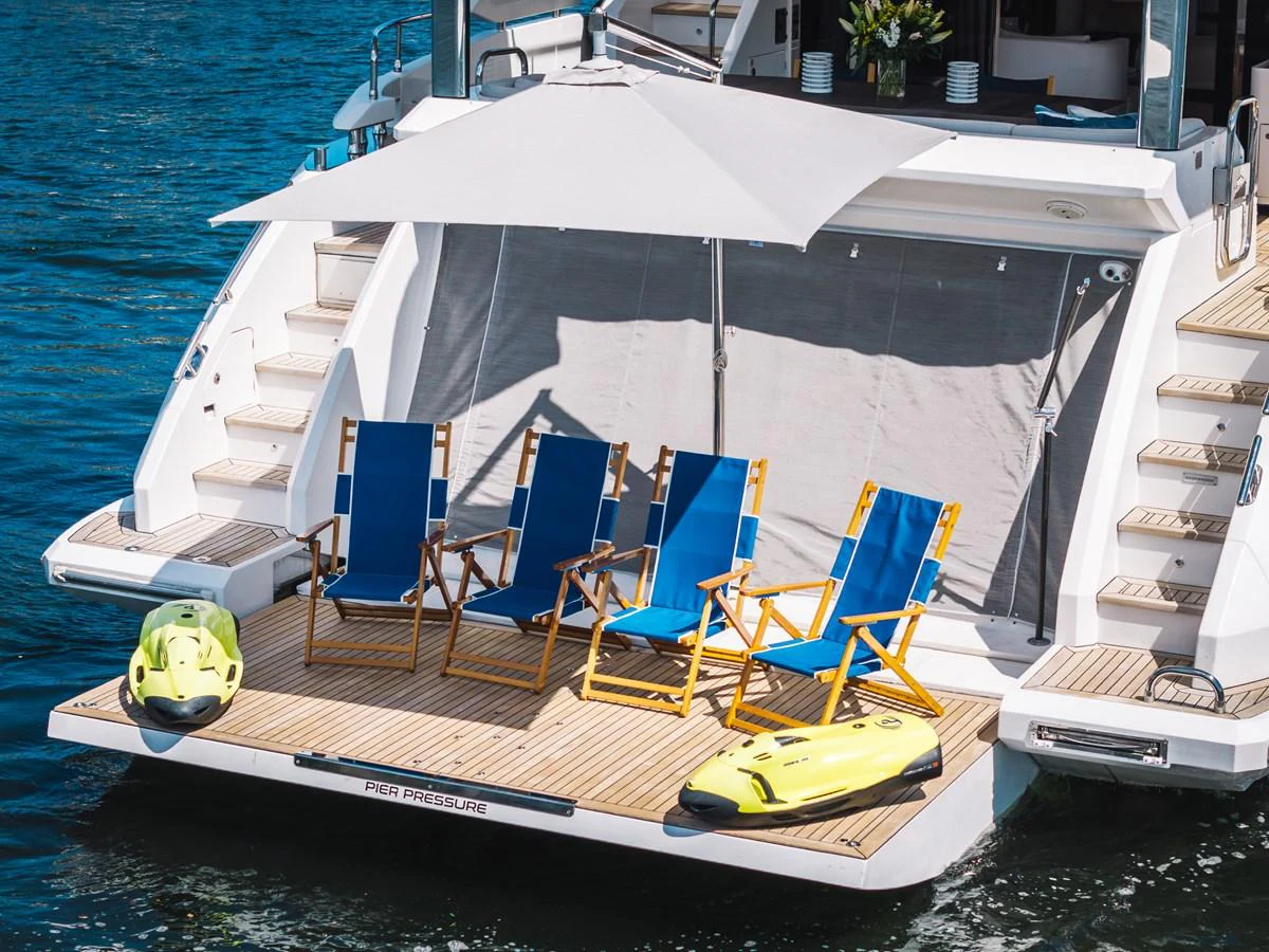 The yacht's swim platform features comfortable seating and water toys, perfect for relaxation and fun on the water. aboard PIER PRESSURE Yacht for Sale