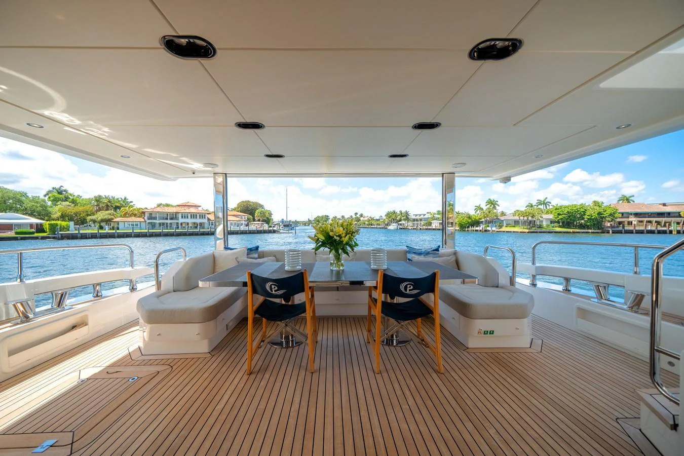 The aft deck offers a spacious and inviting area for alfresco dining with stunning waterfront views. aboard PIER PRESSURE Yacht for Sale