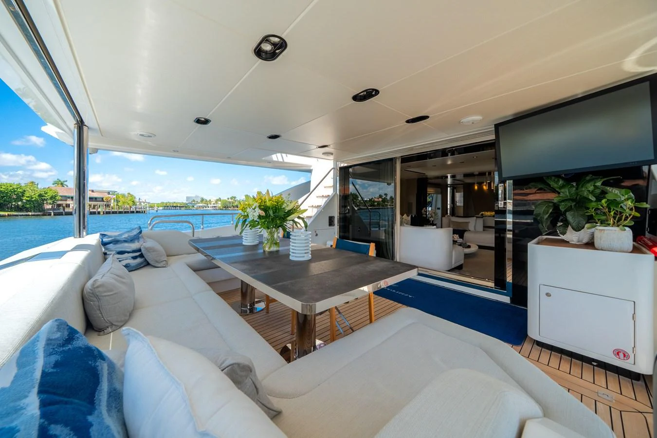 The aft deck offers a spacious and inviting area for relaxation and entertainment with comfortable seating and a dining table. aboard PIER PRESSURE Yacht for Sale