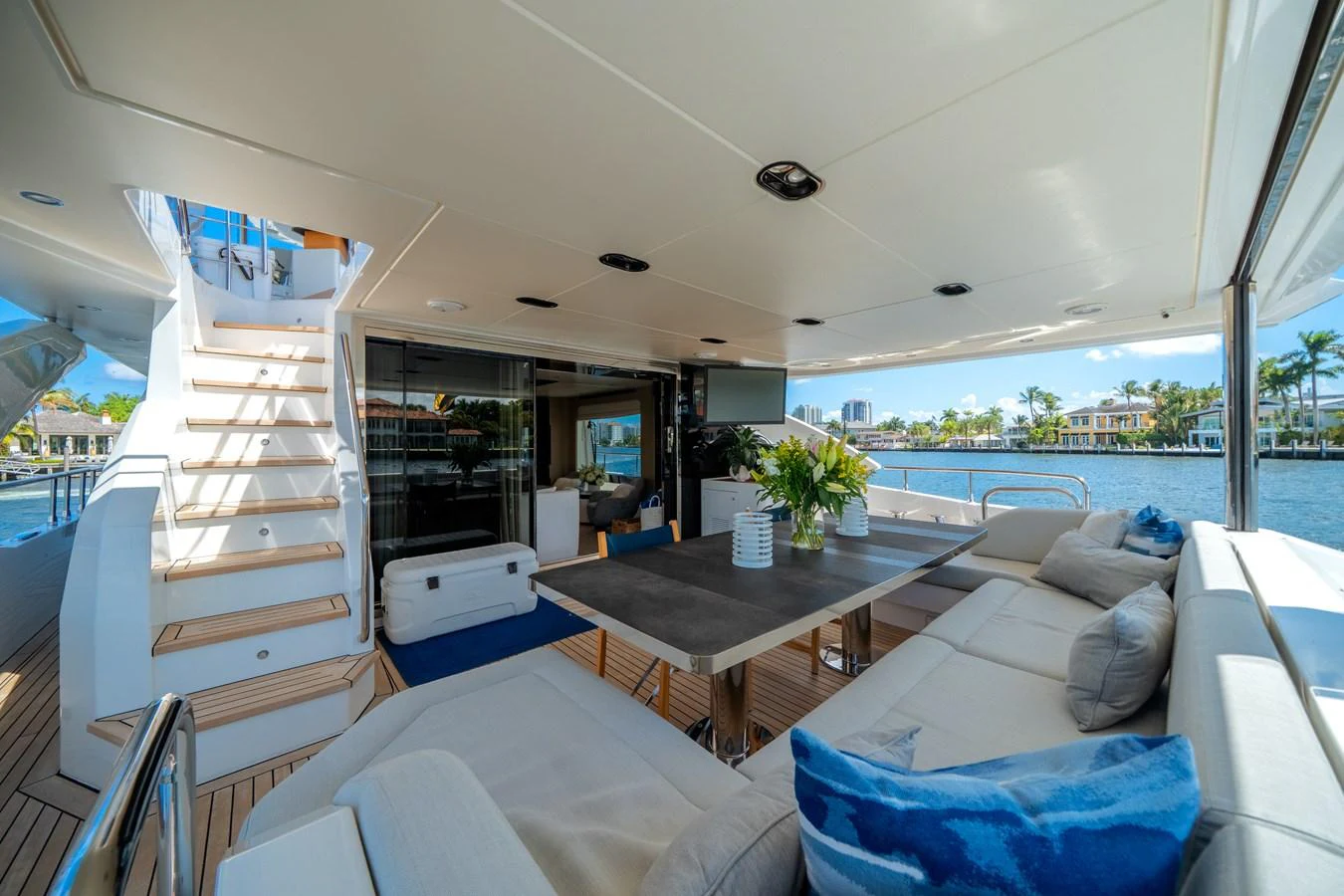 The aft deck features a spacious seating area with a dining table, perfect for alfresco dining and relaxation. aboard PIER PRESSURE Yacht for Sale