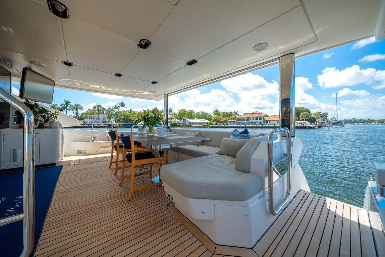 The aft deck offers a spacious and inviting area for relaxation and dining with stunning waterfront views. aboard PIER PRESSURE Yacht for Sale
