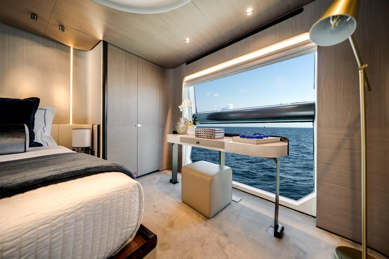 A luxurious stateroom with a large window offering a stunning ocean view. aboard PIER PRESSURE Yacht for Sale