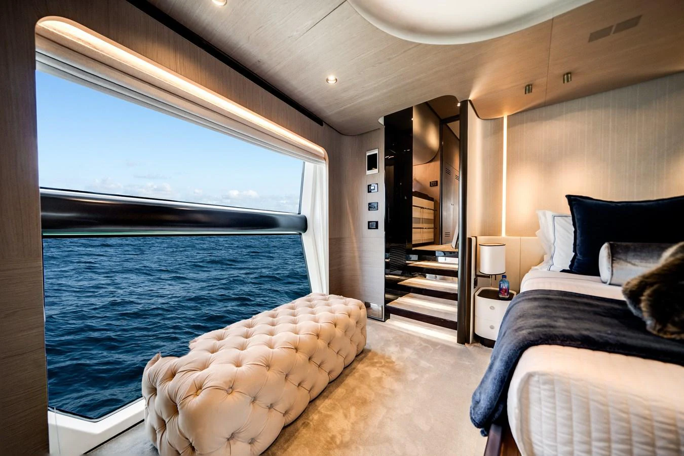 A luxurious stateroom with a large window offering a stunning ocean view. aboard PIER PRESSURE Yacht for Sale