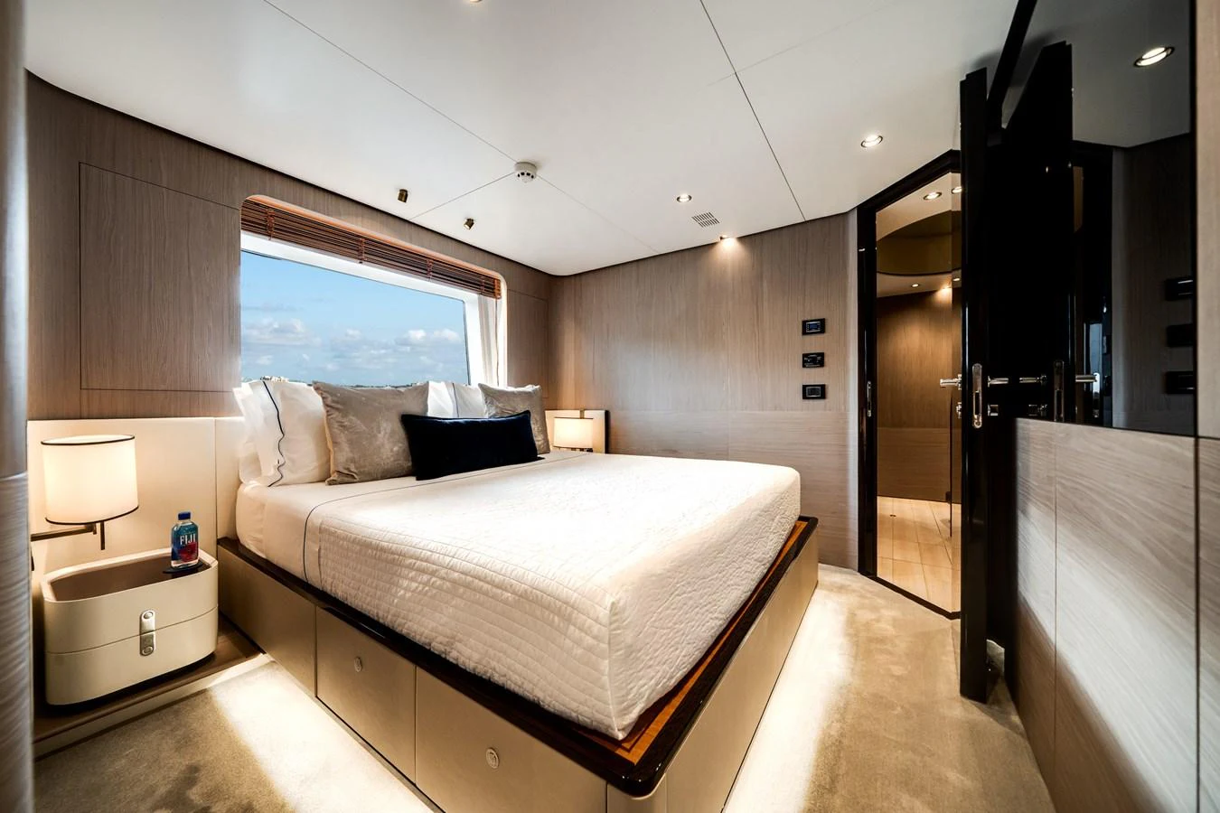 A luxurious stateroom featuring a large bed, modern furnishings, and ample natural light. aboard PIER PRESSURE Yacht for Sale