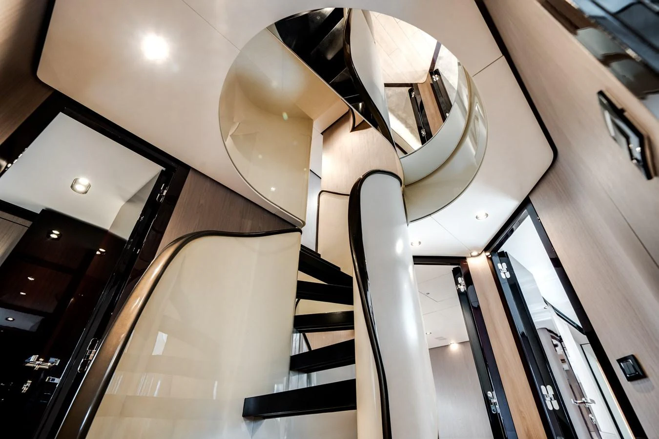 A sleek and modern staircase with elegant curves and reflective surfaces. aboard PIER PRESSURE Yacht for Sale