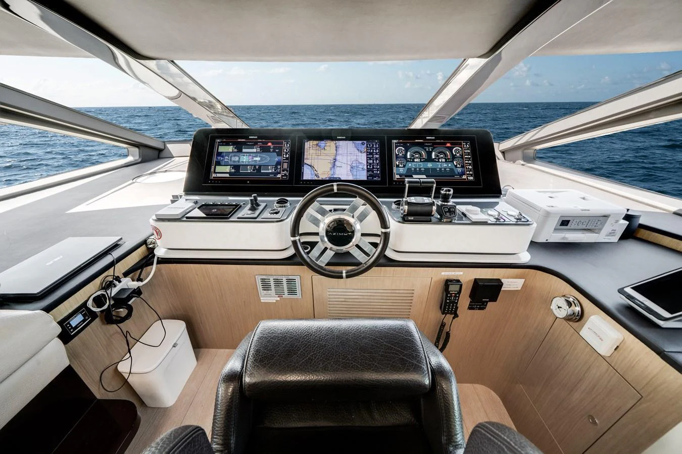 The helm station offers a commanding view with advanced navigation systems and luxurious seating. aboard PIER PRESSURE Yacht for Sale